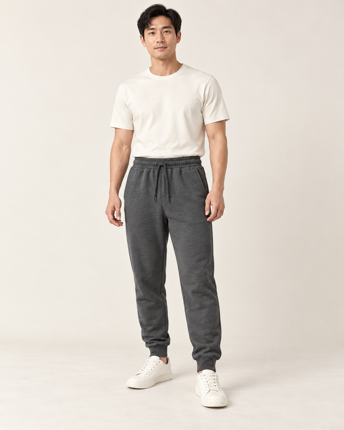 Adult man wearing the COMMON FORM Men's Cuffed Trackpants in Charcoal.