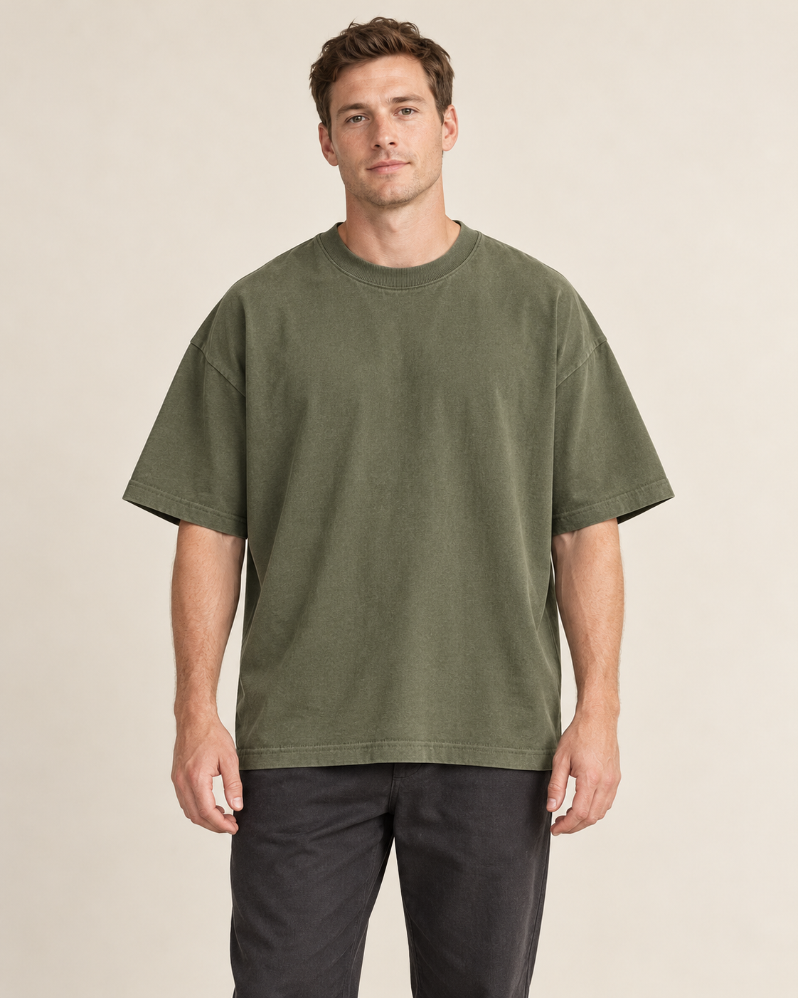 Adult man wearing the COMMON FORM Men's Oversized Tee in Olive.