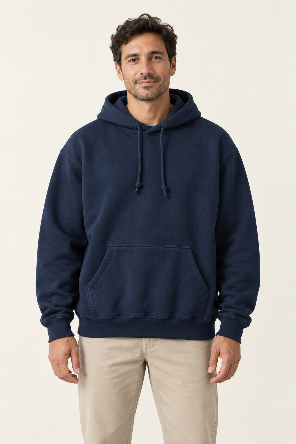 Adult man wearing the COMMON FORM Men's Relaxed Hoodie in Navy.