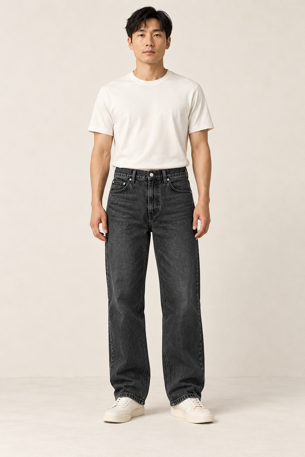 Adult man wearing the COMMON FORM Men's Relaxed Jean in Washed Black.