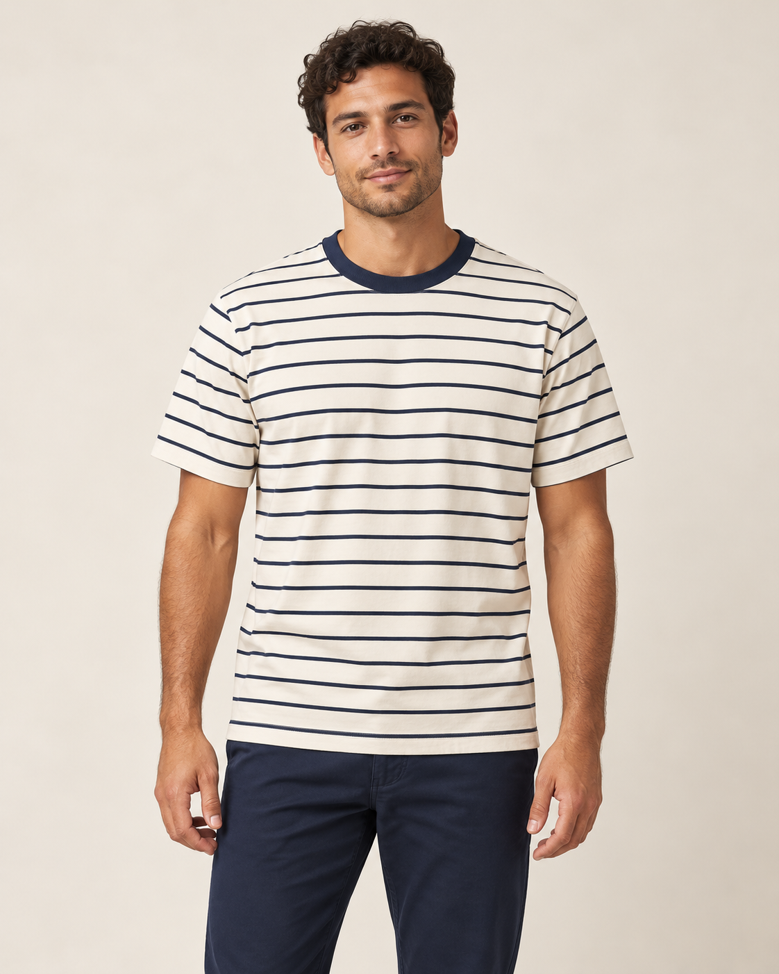 Adult man wearing the COMMON FORM Men's Stripe Crew Tee in Cream/Navy.
