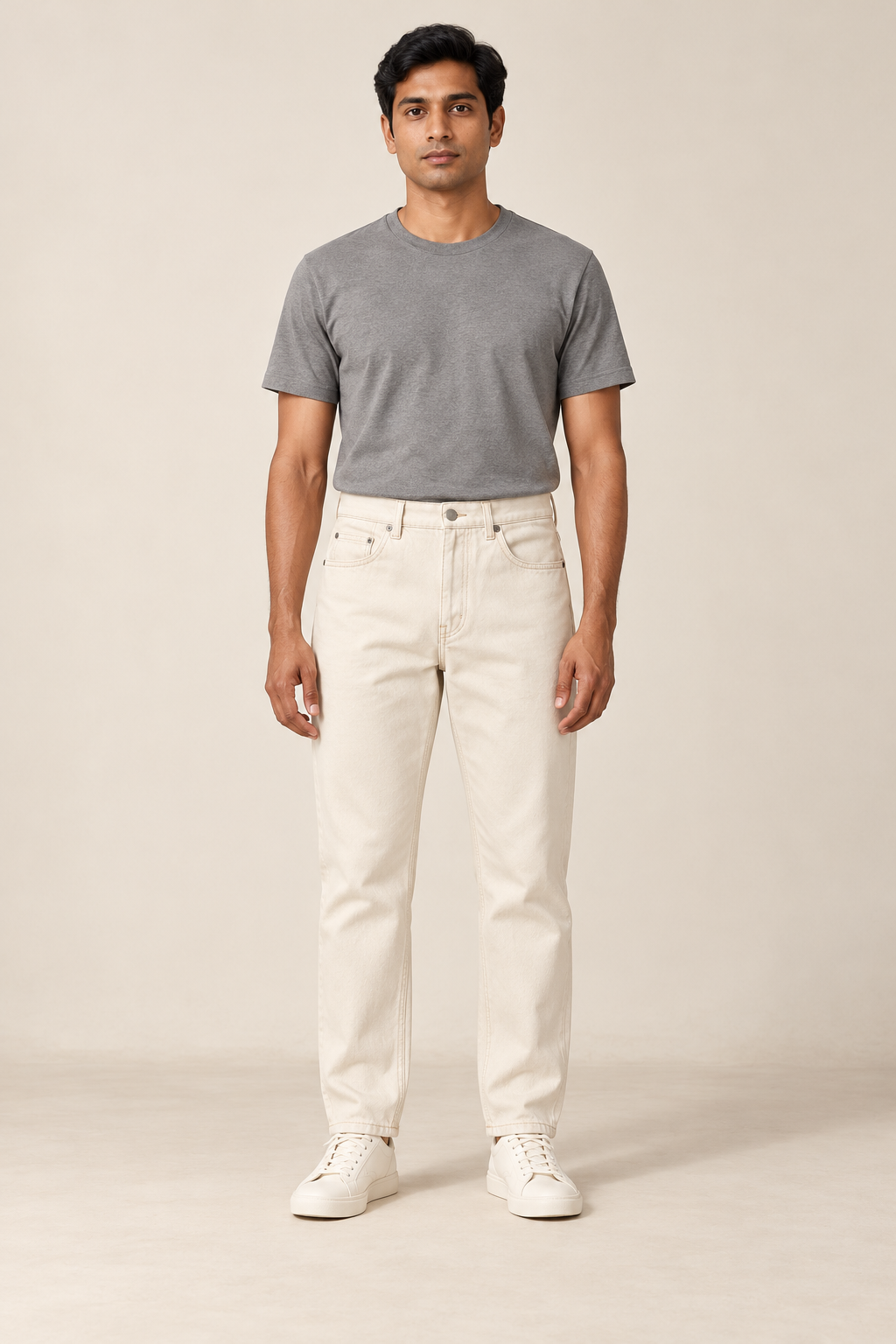 Adult man wearing the COMMON FORM Men's Tapered Jean in Ecru.