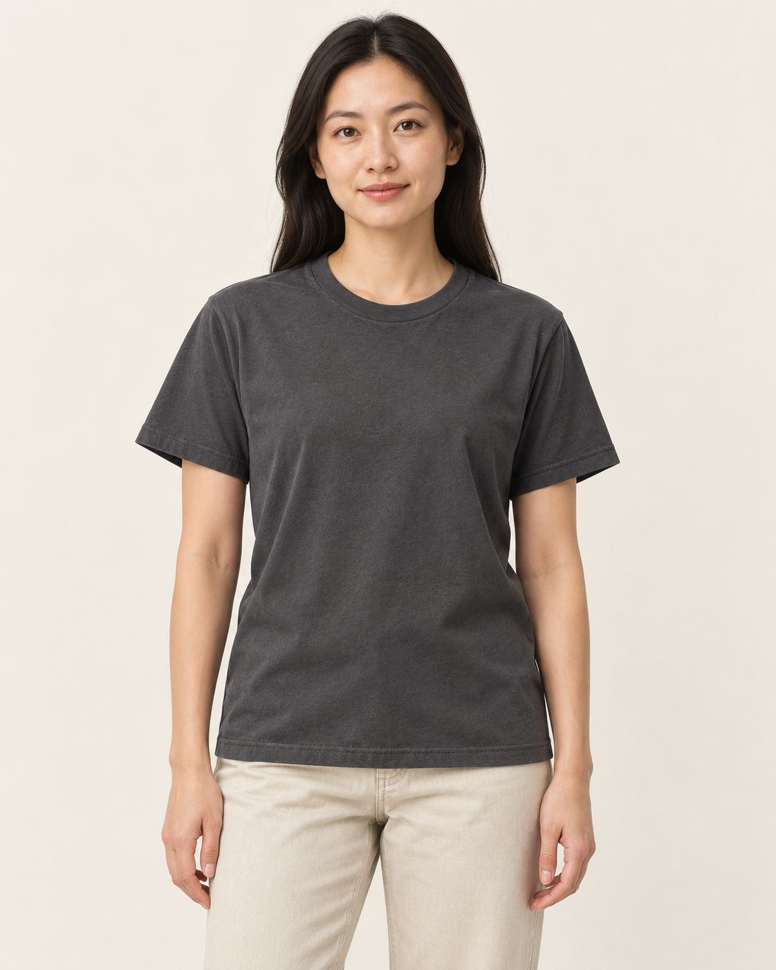 Adult woman wearing the COMMON FORM Women's Core Crew Tee in Charcoal.