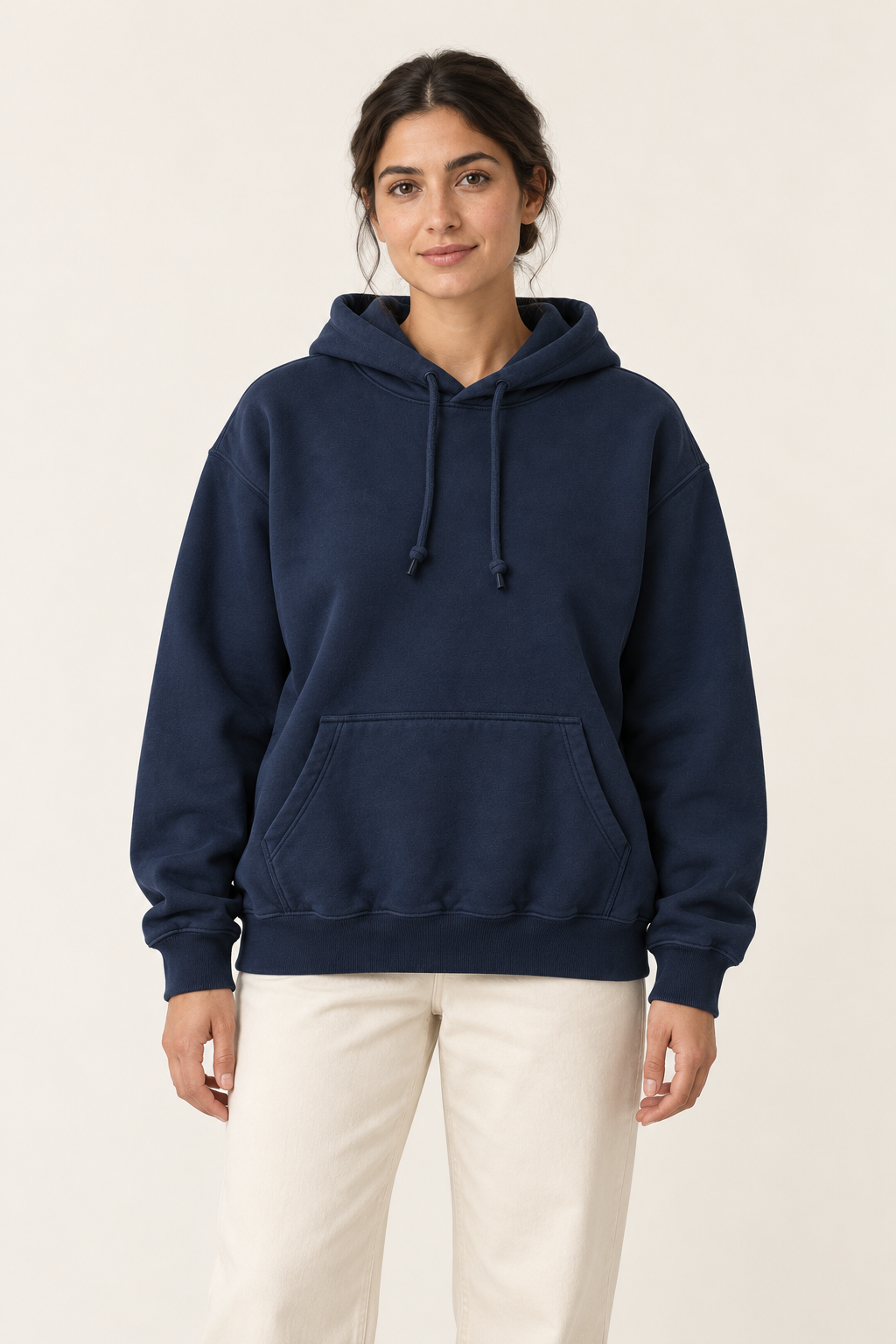 Adult woman wearing the COMMON FORM Women's Relaxed Hoodie in Navy.