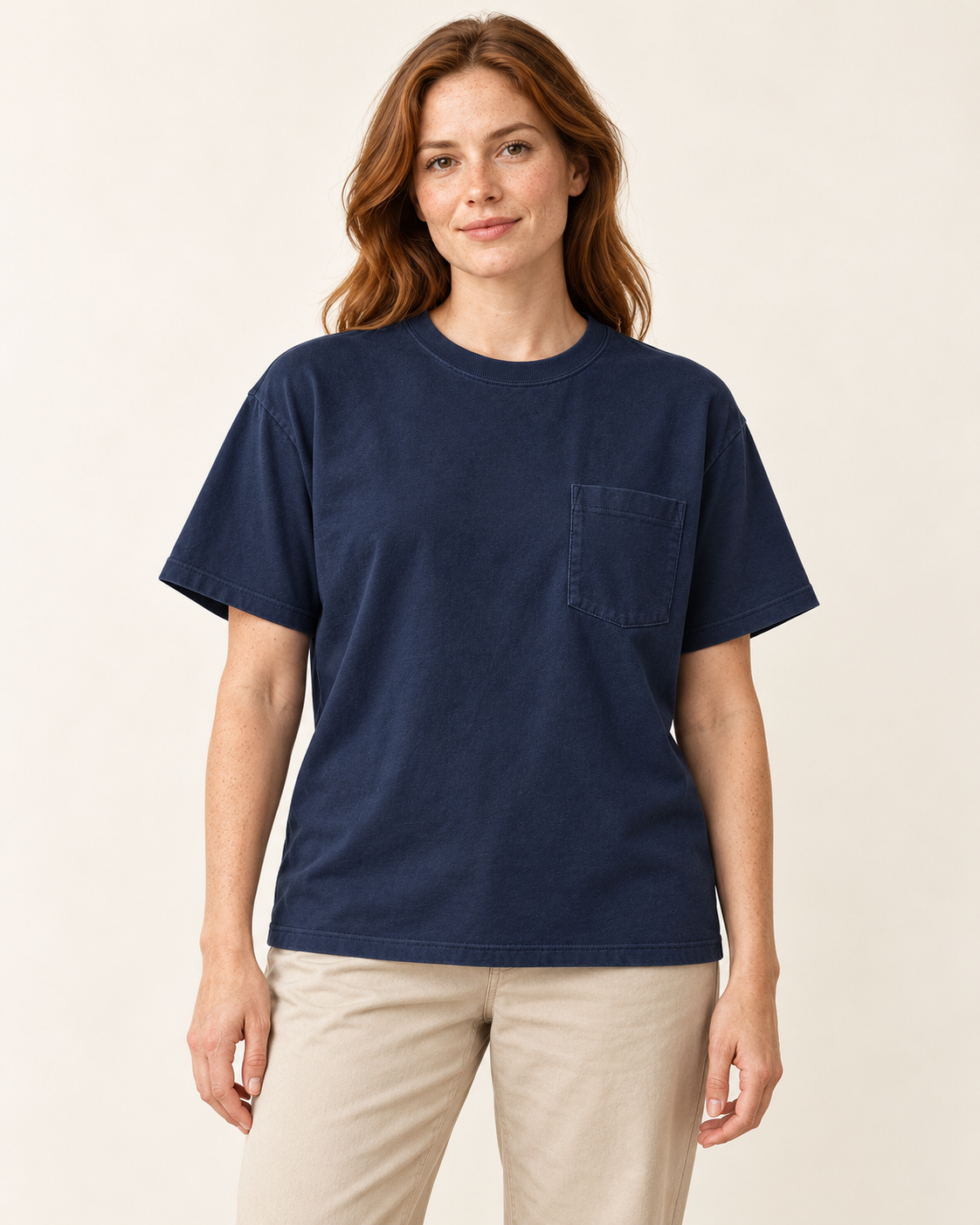 Adult woman wearing the COMMON FORM Women's Relaxed Pocket Tee in Navy.
