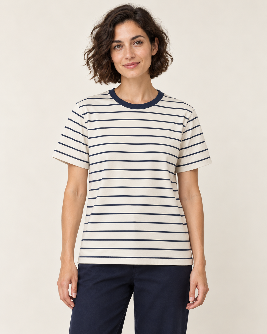 Adult woman wearing the COMMON FORM Women's Stripe Crew Tee in Cream/Navy.
