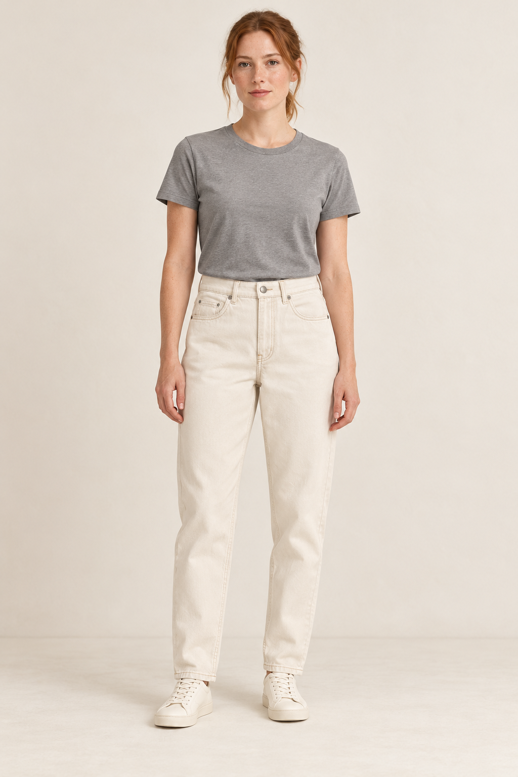 Adult woman wearing the COMMON FORM Women's Tapered Jean in Ecru.