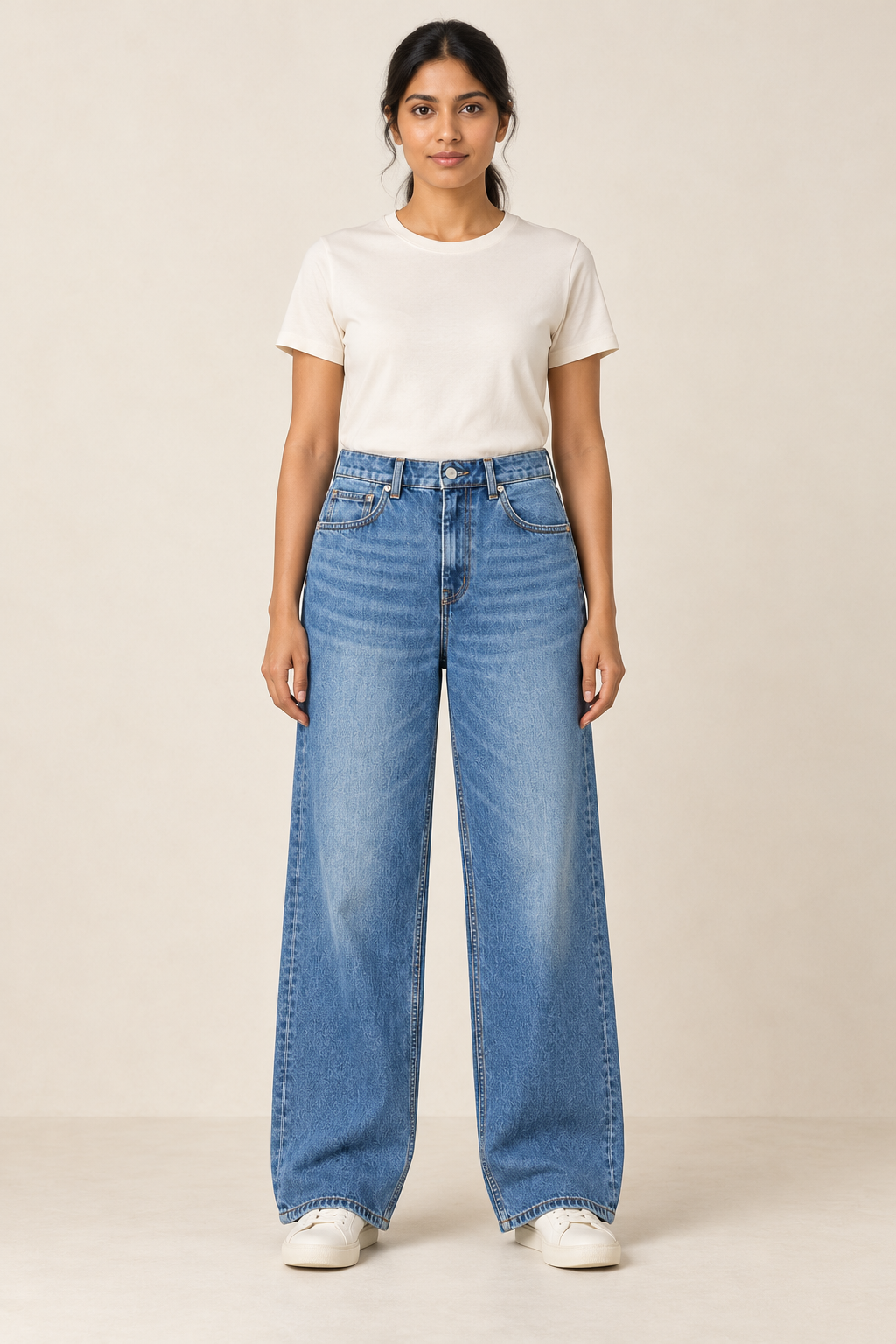 Adult woman wearing the COMMON FORM Women's Wide Leg Jean in Mid Blue.
